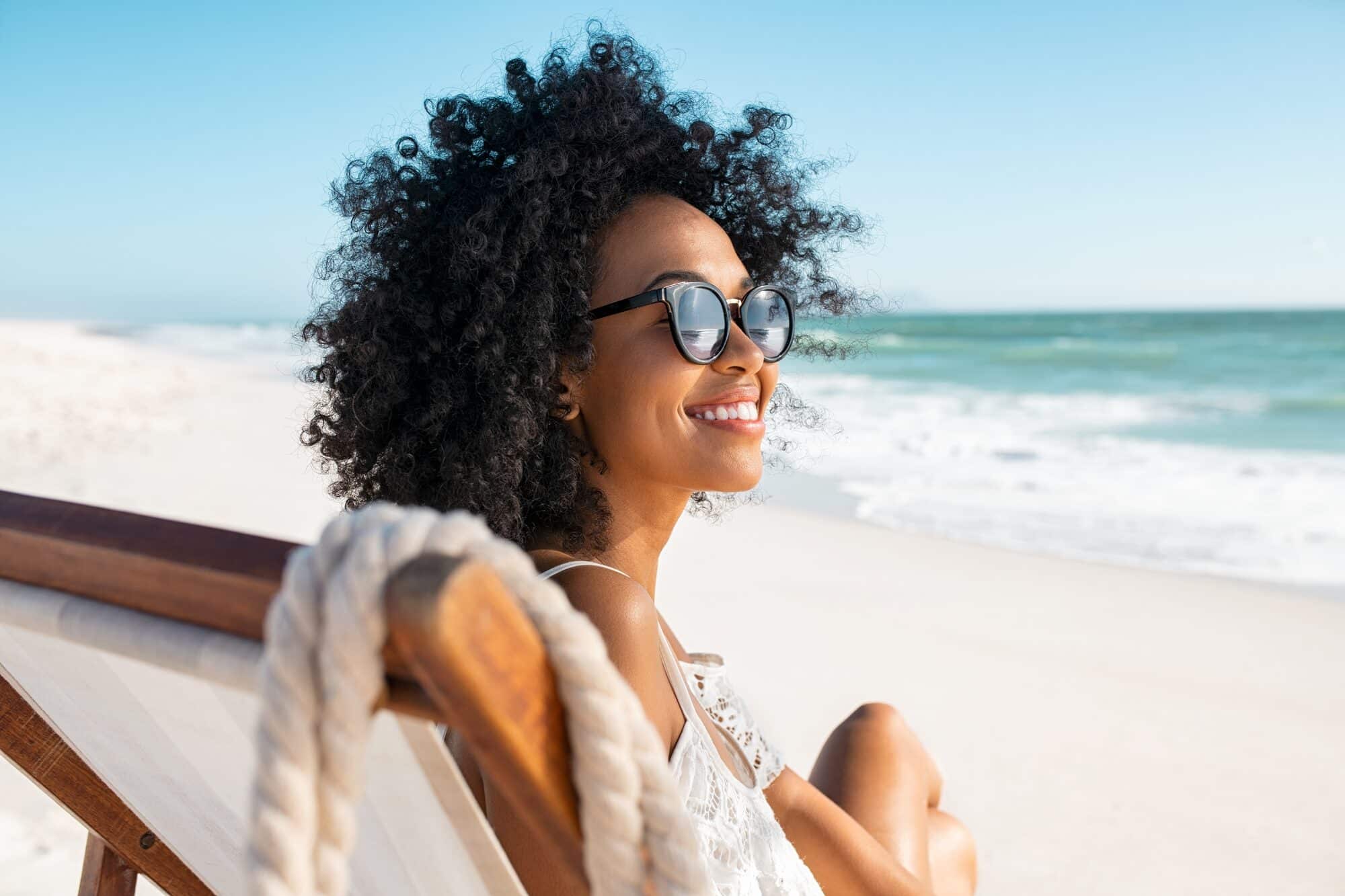 Wearing sunglasses outdoors to protect the eyes from UV exposure